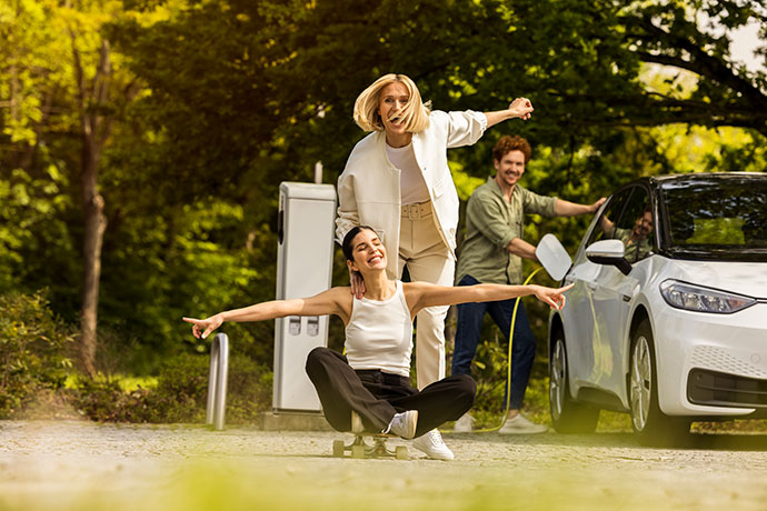 Freunde tanken Elektro-Auto im Garten